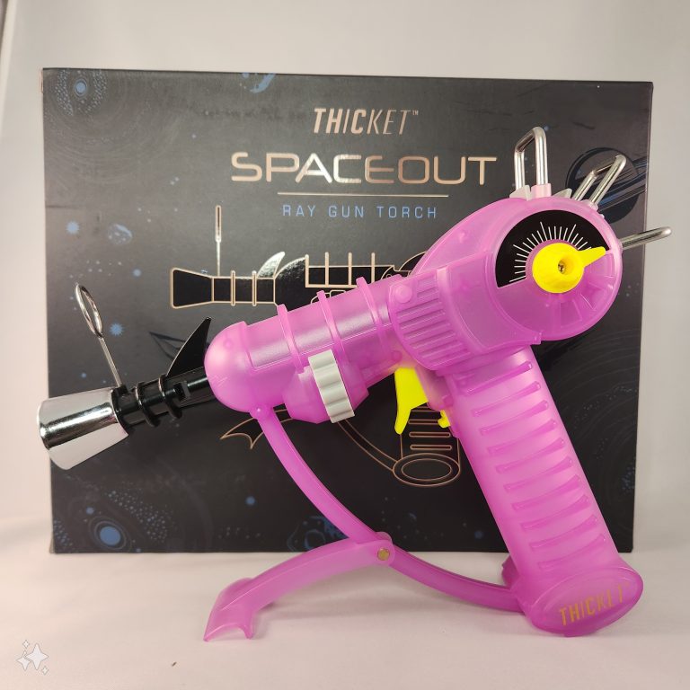 PURPLE THICKET RAY GUN TORCH IN FRONT OF A BLACK BOX LABELED SPACED OUT THICKET