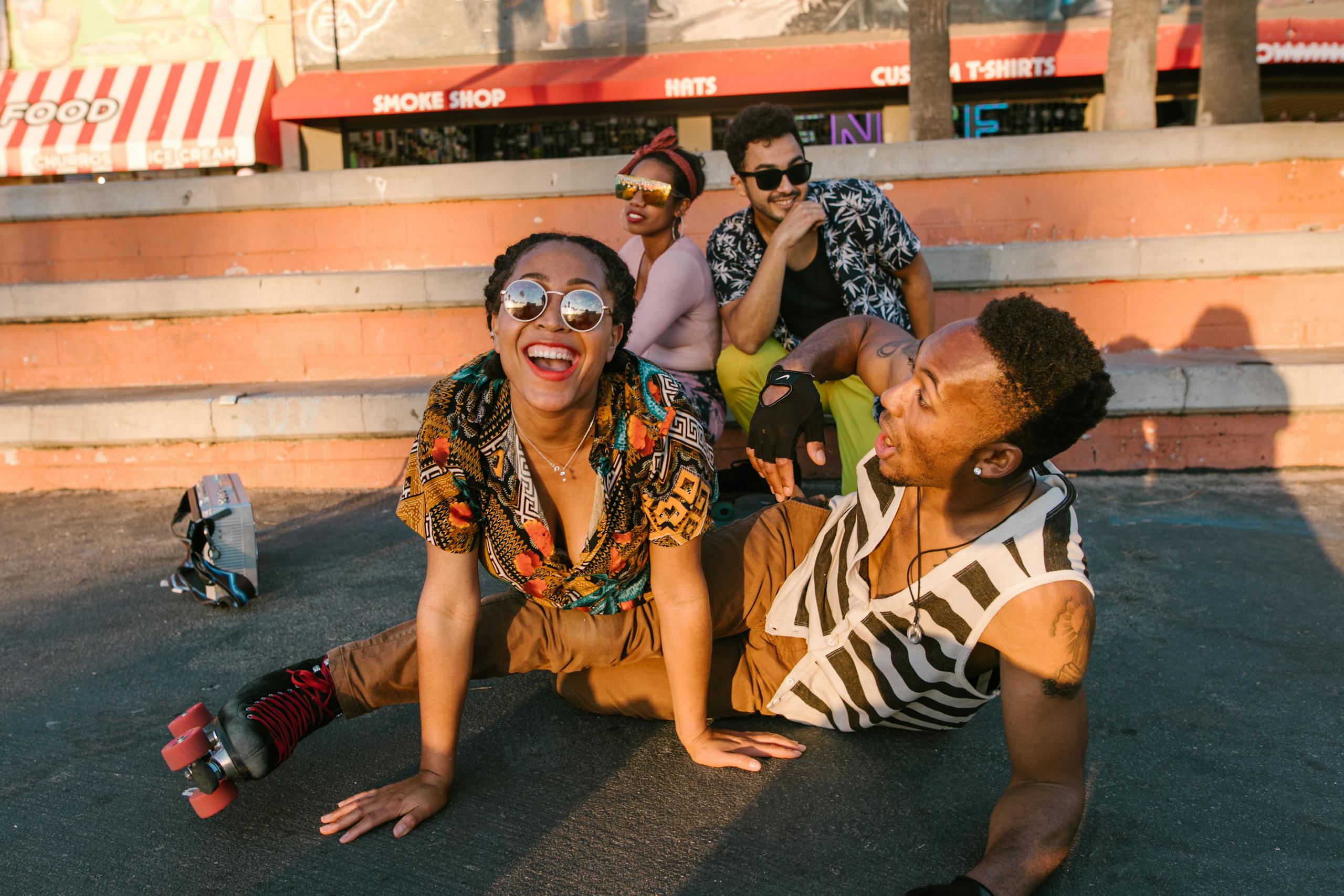 Diverse group of friends enjoying a sunny day roller skating together outdoors.